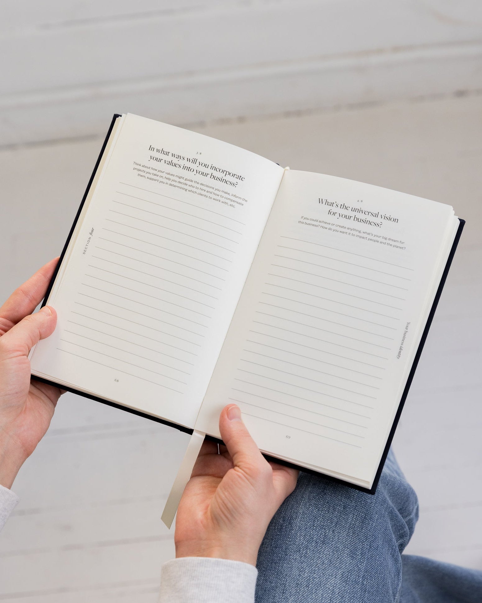 Person holding Bedside Business Plan with a white background