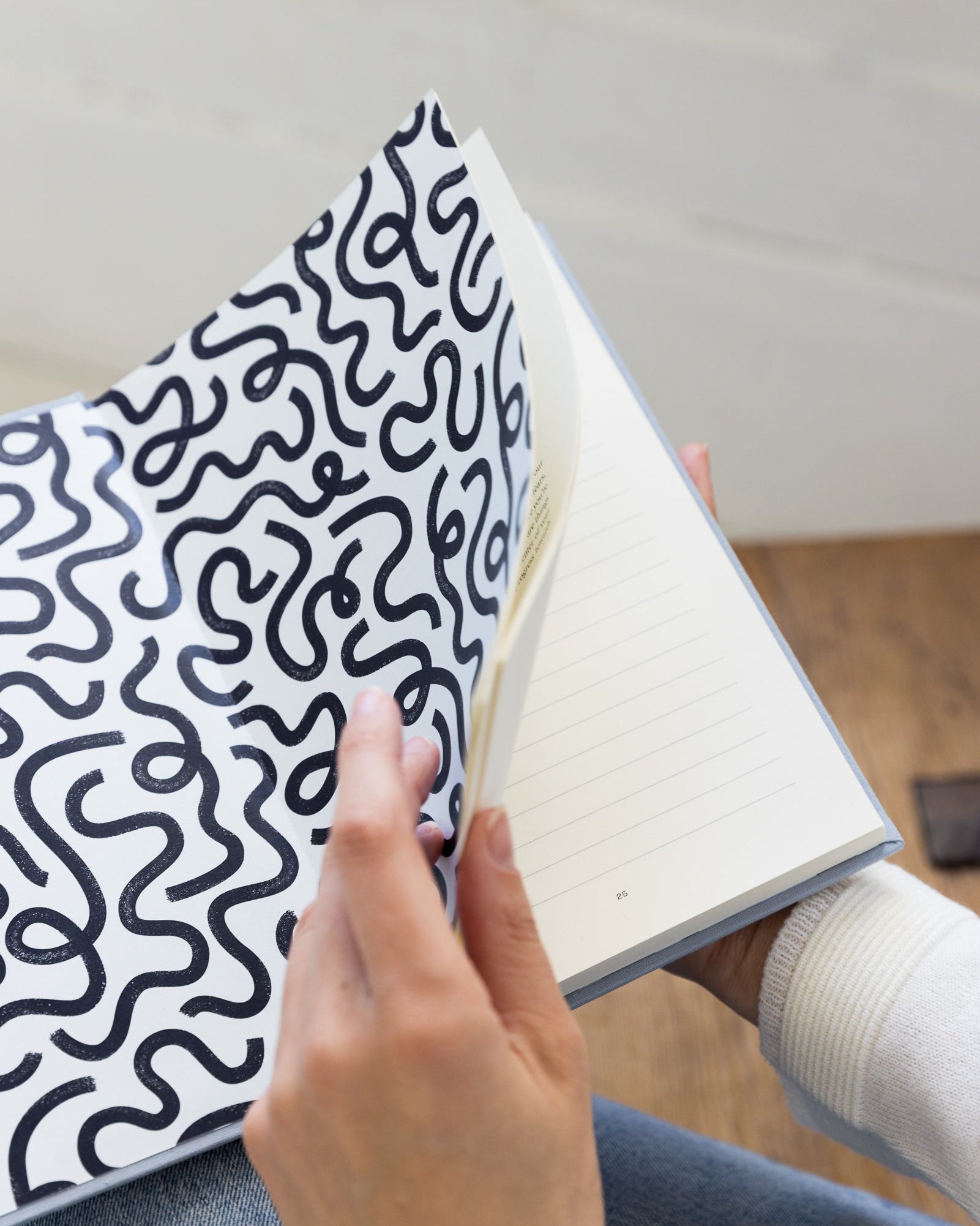 Hand holding Employee to Entrepreneur open with a black and white patterned cover