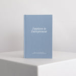Blue guided journal titled 'Employee to Entrepreneur' on a white surface with a light gray background