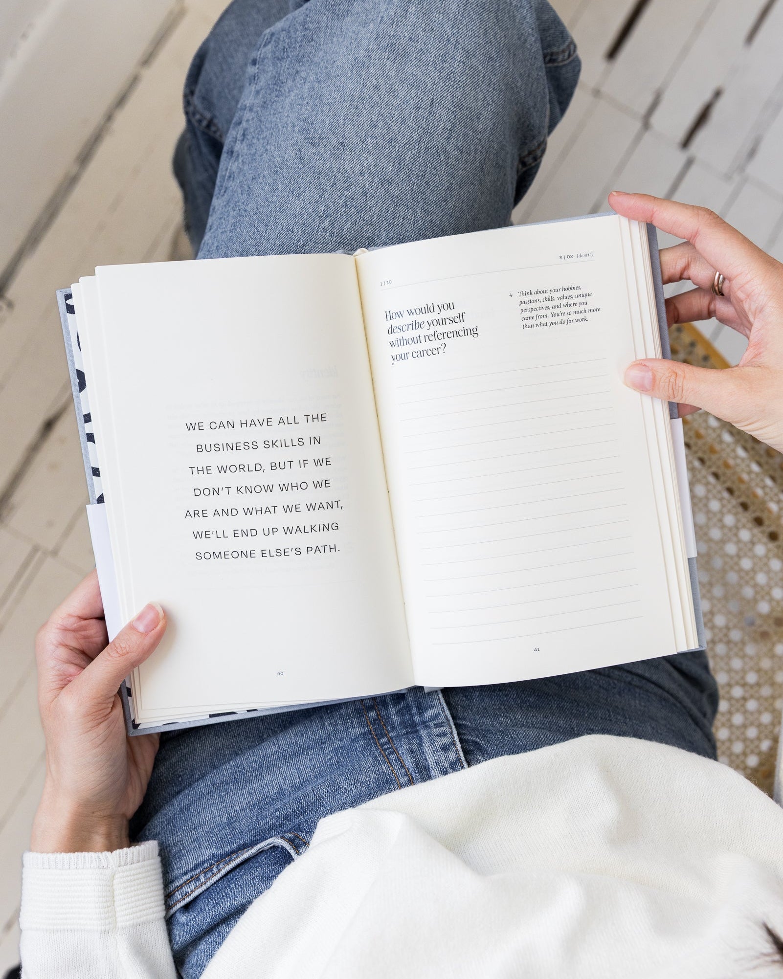 Person reading Employee to Entrepreneur with text on a wooden floor.
