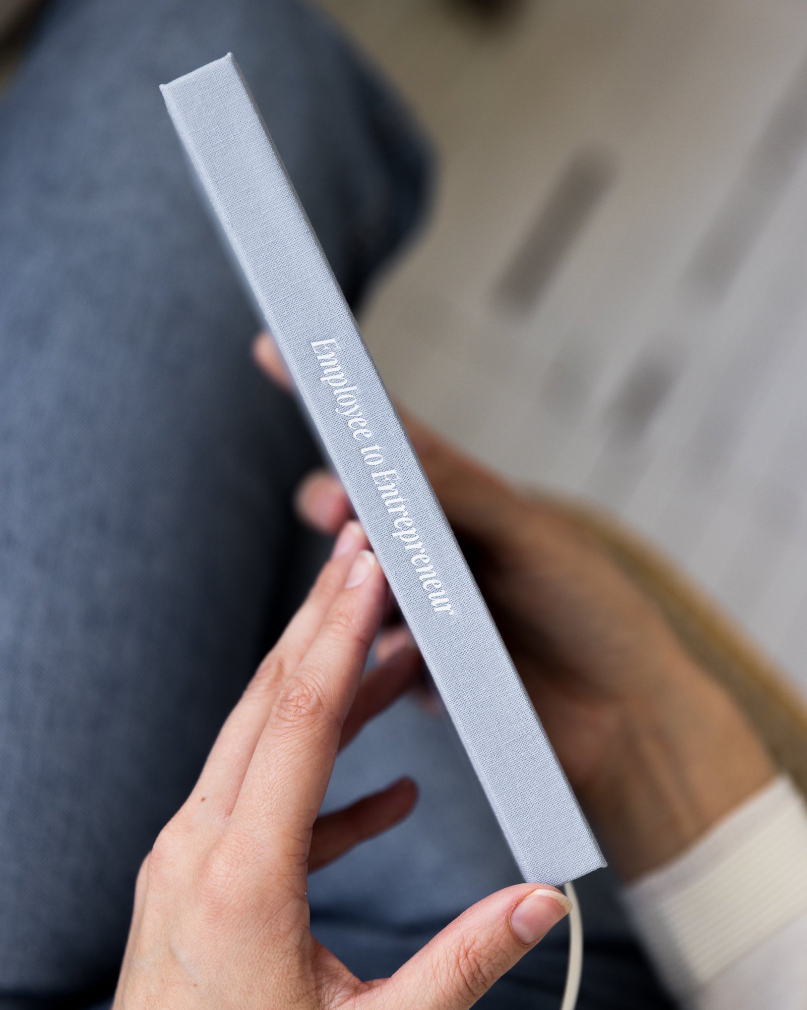 Person holding Employee to Entrepreneur showing spine