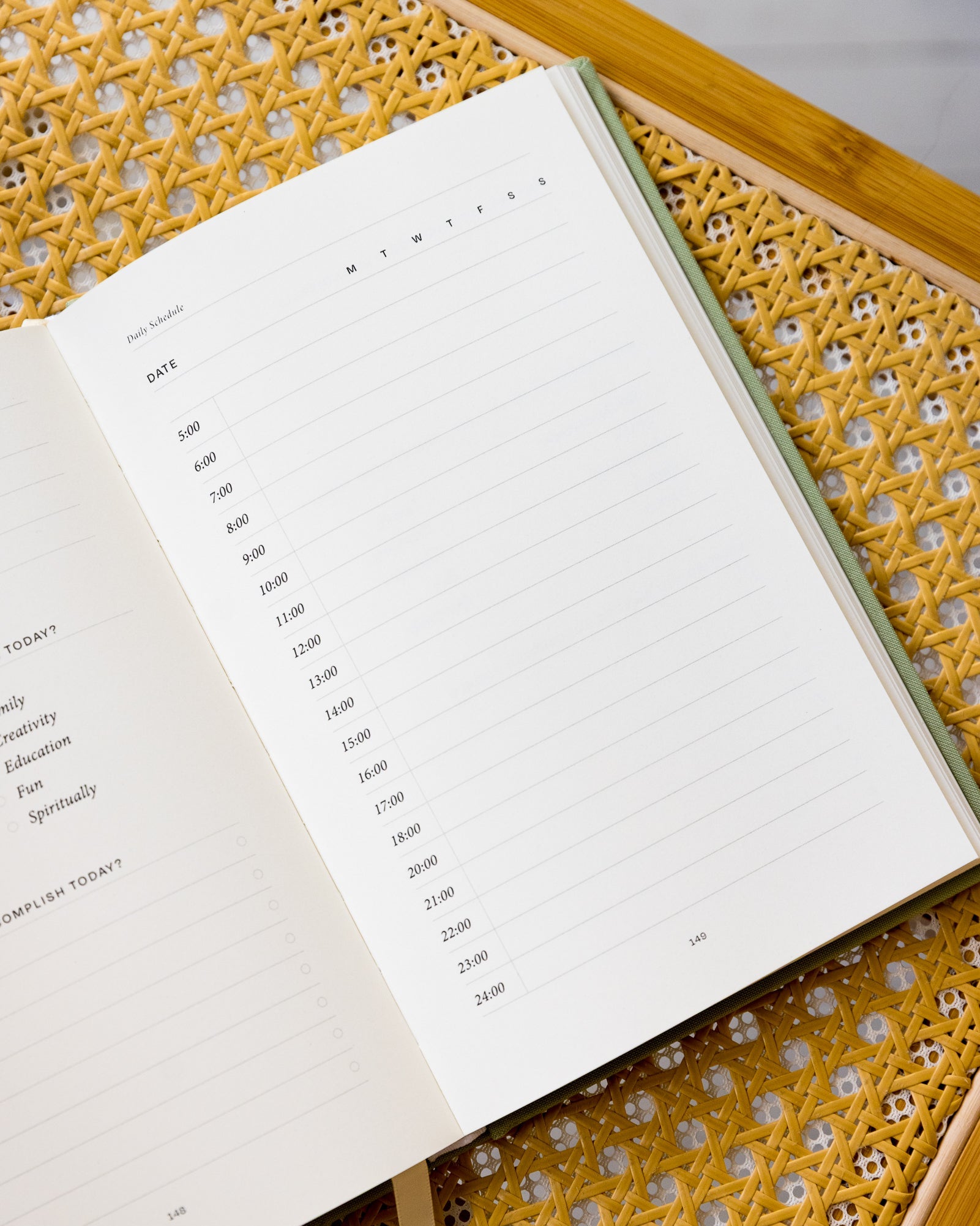 The Anti Retirement Plan Day Planner open on yellow chair