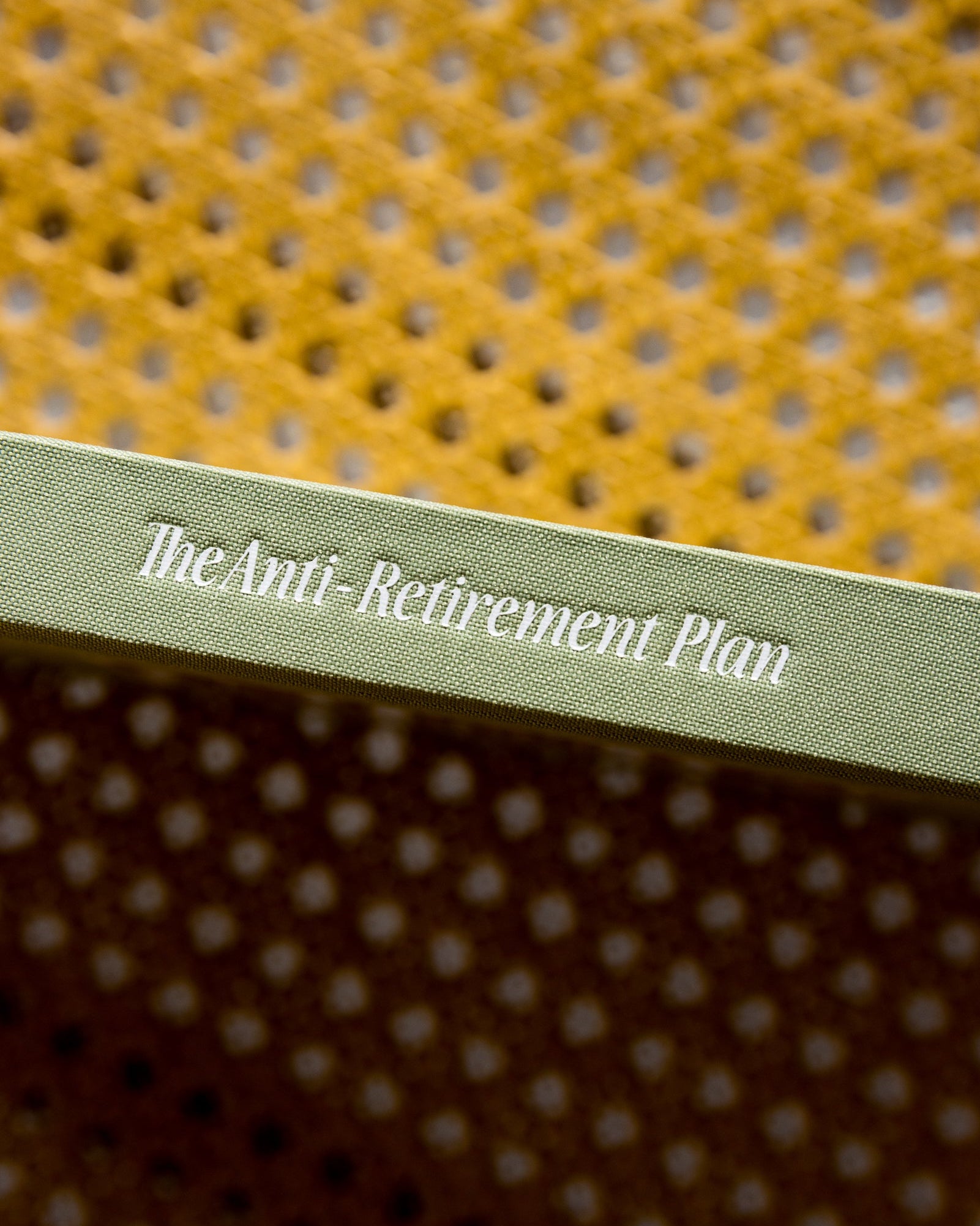 Cover of a book titled 'The Anti-Retirement Plan' with a textured yellow and brown cover.